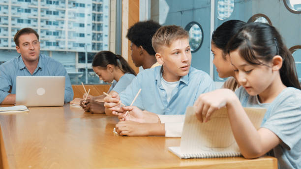 istock Teacher and student clap hand to celebrate for successful project. Edification. 2052801359