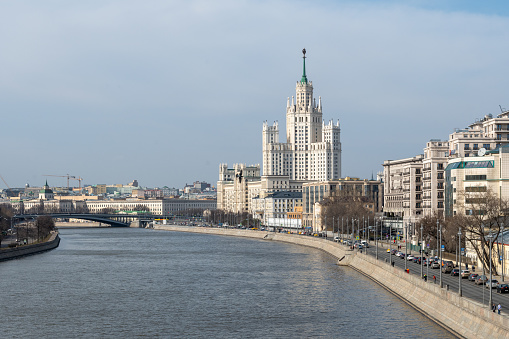 View of the Kotelnicheskaya embankment of the Moscow River. Characteristic architectural structures of the Stalinist Empire style surrounded by later Soviet style and modern solutions.