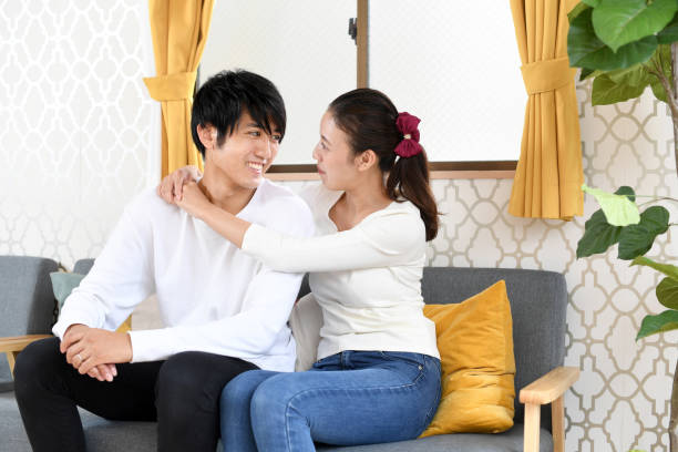 istock Asian couple hugging on the sofa 2052822820