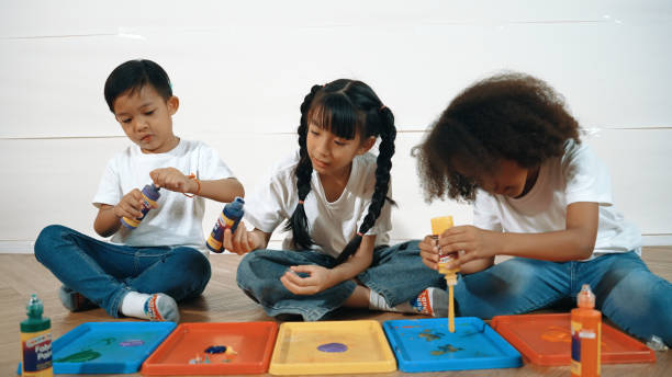 istock Group of diverse young student mixing color while sitting together. Erudition. 2052826496