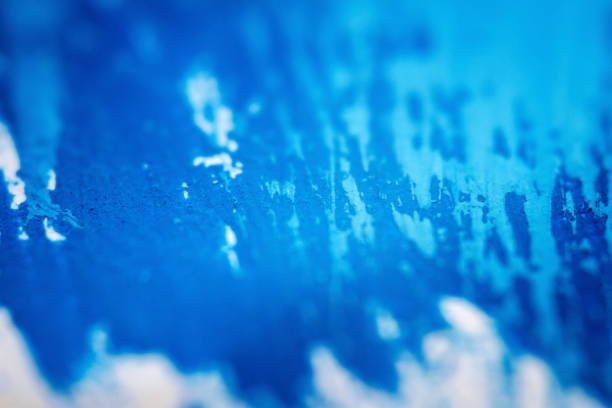 Extreme close up of blue acrylic paint texture showing brush strokes. Selective focus.