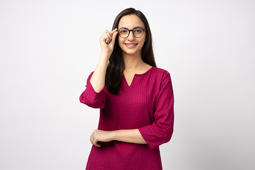 Portrait of attractive cheerful girl touching specs looking at camera copy space isolated over white color background