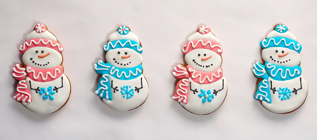 Snowmen made of gingerbread on a background of pure white background