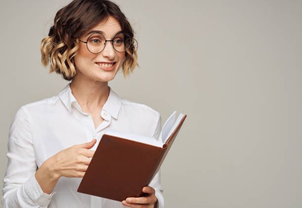 istock woman with notepad on gray background indoors gesturing with hands work office education 2052844038