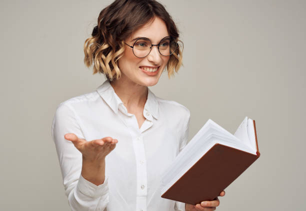 istock woman with notepad on gray background indoors gesturing with hands work office education 2052850894