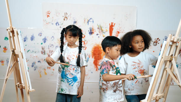 istock Diverse student painted or draw canvas at stained wall in art lesson. Erudition. 2052857798