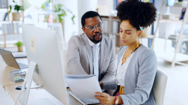 istock Discussion, portfolio or business people with project feedback review or report with data for agenda. Black man, paperwork info or woman speaking for collaboration, teamwork or consulting in office 2052859894