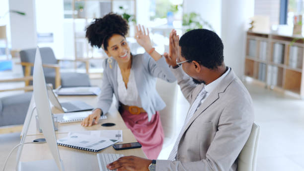 istock Business people, high five and computer or documents for planning success, office goals and achievement or teamwork. Happy manager or woman with hands together, well done and celebration for startup 2052859901