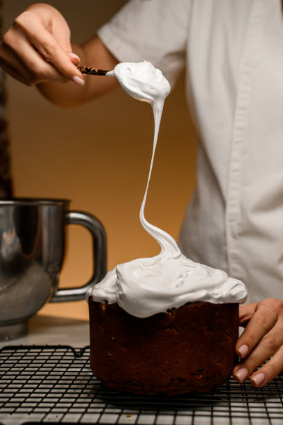 istock Easter cake gets a finishing touch with whipped cream 2052861526