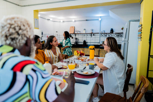 istock Friends talking and eating on hotel restaurant 2052866259