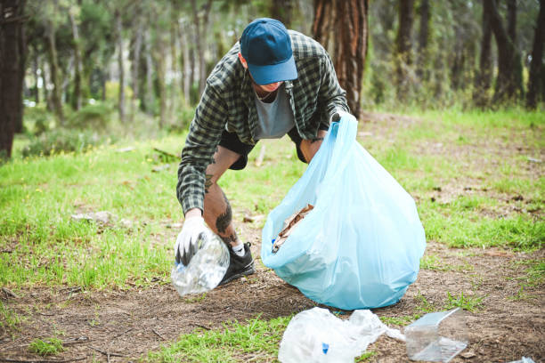 istock male volunteer collecting garbage in the forest 2052874904