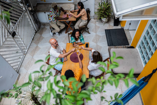 istock High angle view of friends toasting with beer on hostel outdoors restaurant 2052886624