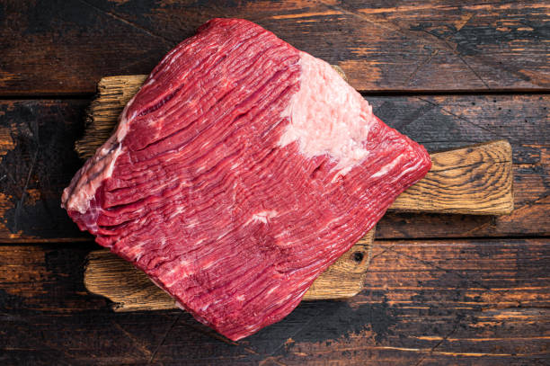 istock Ready for cooking beef brisket, raw meat. Wooden background. Top view 2052890300