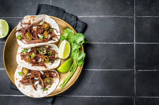 istock Mexican Beef Barbacoa Tacos with Cilantro and Onion. Black background. Top view. Copy space 2052890824