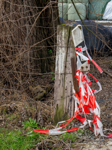 istock an old, damaged delineator post with red warning tape 2052891408