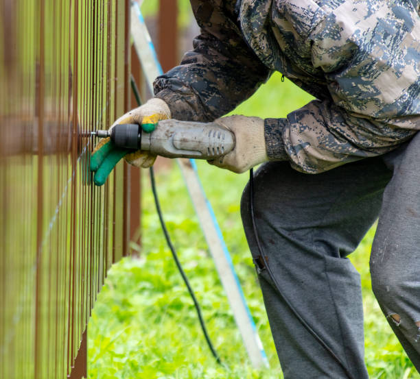 istock Workers install a metal profile fence 2052899222