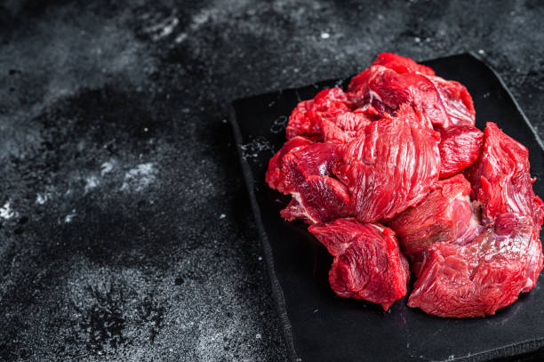 istock Fresh Raw diced beef veal meat for cooking Shish kebab. Black background. Top view. Copy space 2052904407