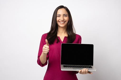 Woman showing blank black laptop computer screen