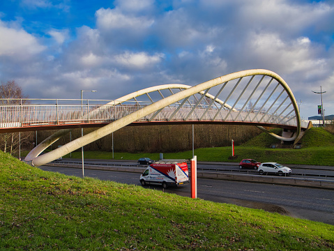 St Helens, UK - 4 Jan 2024: The Steve Prescott Bridge across the A58 in St Helens, Merseyside, UK. A memorial to the rugby league player who died after a long fight with cancer.