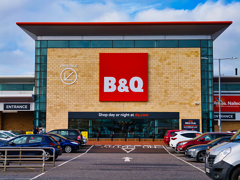 St Helens, UK - Jan 4 2023: The frontage and brand logo of a branch of the UK DIY store B&Q, taken in a local retail park on St Helens, UK on a sunny afternoon.