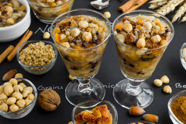 istock Traditional Turkish Dessert Noah's Pudding,Asure and ingredients on black surface with handwriting letters 2052915852