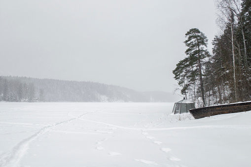 Walking on a Snow-covered frozen lake in a blizzard in Nuuksio National Park, Espoo