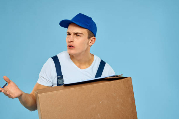 istock Man worker with cardboard box delivery loader lifestyle blue background 2052931070
