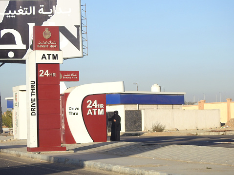 Cairo, Egypt, December 16 2023: Automated Teller Machine drive-thru lane providing access to ATMs using an automobile in New Cairo Egypt for Banque Misr or Masr Bank in a Gas station with fuel prices, selective focus