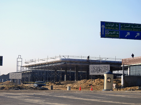 Giza, Egypt, January 6 2024: a fuel gas and oil station under construction, a petrol gas station with concrete columns being processed on the ring road in Giza, fuel up gas station under construction, selective focus