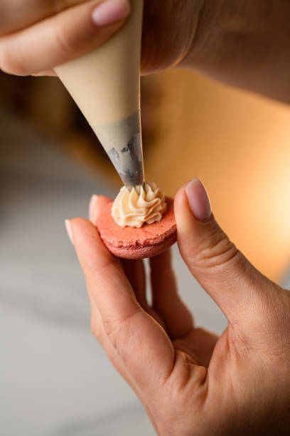 istock Perfecting beige macarons in the making by chief 2052950692