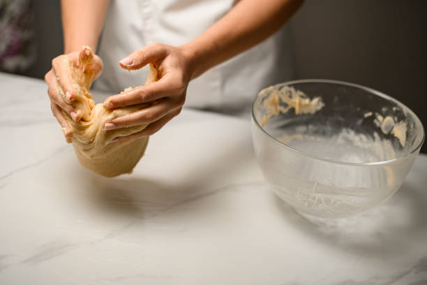 Cooks hands at work. Kneading dough for a delightful dish