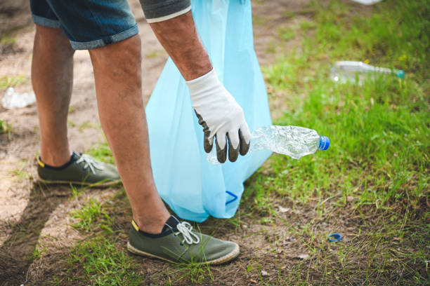 istock male volunteer collecting garbage in the forest 2052962448