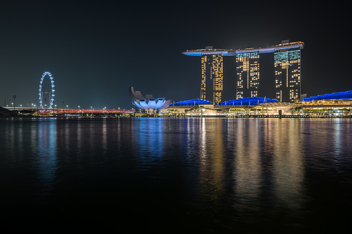 Singapore, Singapore - December 29, 2021: Letters spelling out 'DREAM' are cordoned off with a red and white barrier tape, with the Marina Bay Sands hotel visible in the background.
