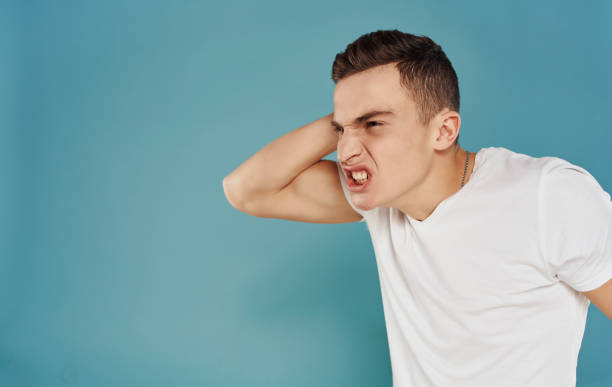 istock man in white t-shirt dissatisfaction emotions blue background 2052982703