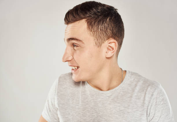 istock handsome man fun in white t-shirt close-up emotions 2053000976