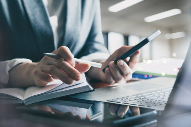 istock Manager works in the office on a computer and mobile. 2053011486