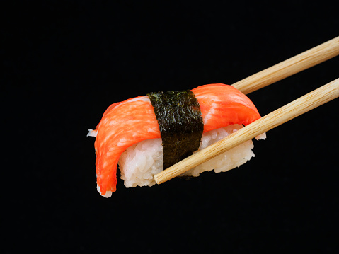 Japanese cuisine: Crab meat sushi on black background