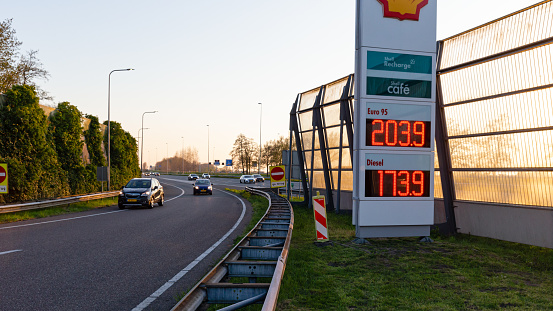Netherlands, South Holland, Reeuwijk, April 19th 2023, Dutch cars (Opel, Seat) approaching on the acces road from the A12 highway near Gouda and Reeuwijk at sunset to Shell gas station 'De Andel' on a sunny day in springtime, the A-12 is a 137 kilometer long highway crossing the country from The Hague in the East to Germany in the West