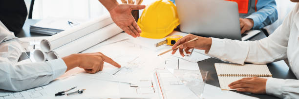 istock Engineer partner drawing and working on blueprint design together. Insight 2053039023