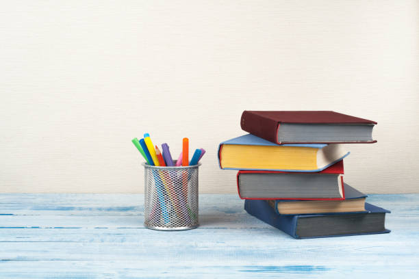 istock Book stacking. Open book, hardback books on wooden. Back to school. Copy space for text. 2053042187