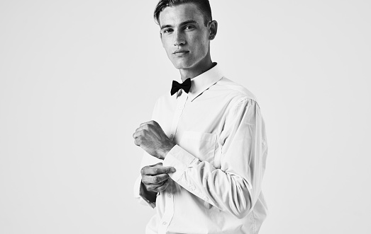 Side view of a handsome gentleman in a shirt in a bow tie. High quality photo