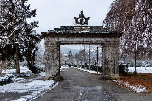 Stone portal to the Sihlfeld cemetery in Zurich in winter, snow and cold