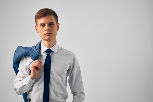 man in shirt with tie and jacket on his shoulders fashion work. High quality photo