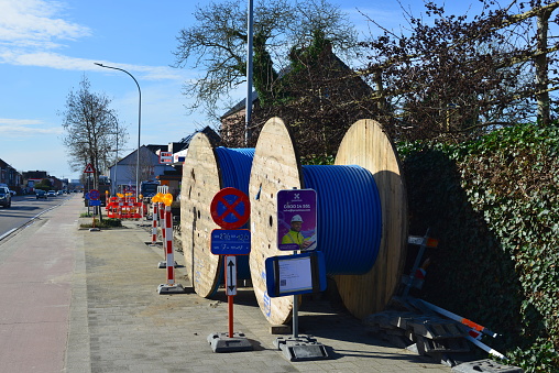 Leuven, Flemish-Brabant, Belgium - March 2, 2024: works stopped during the weekend and safety infrastructure along footpath installed. Proximus board connecting Belgium to fiber, network of future