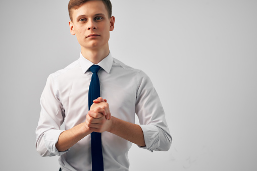 man in white shirt with tie gesturing with hands success emotions self-confidence. High quality photo