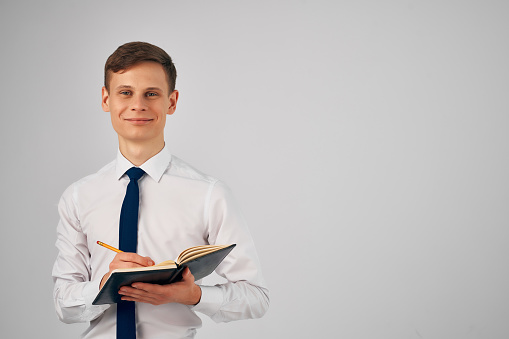 Cheerful business man in shirt with tie notebook work manager. High quality photo