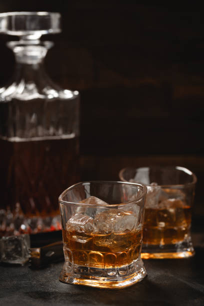 istock Glasses of whiskey with ice and decanter 2053104528
