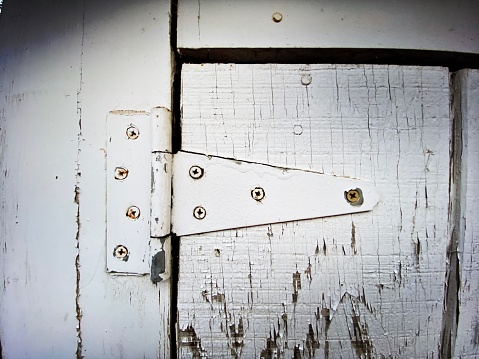 Piano Hinge on a White Weathered Door