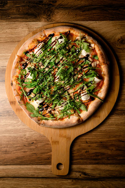 Fresh and flavorful close up from above pizza with vibrant arugula.