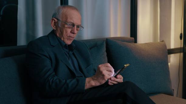 istock Elderly man typing on phone with stylus pen 2053167207